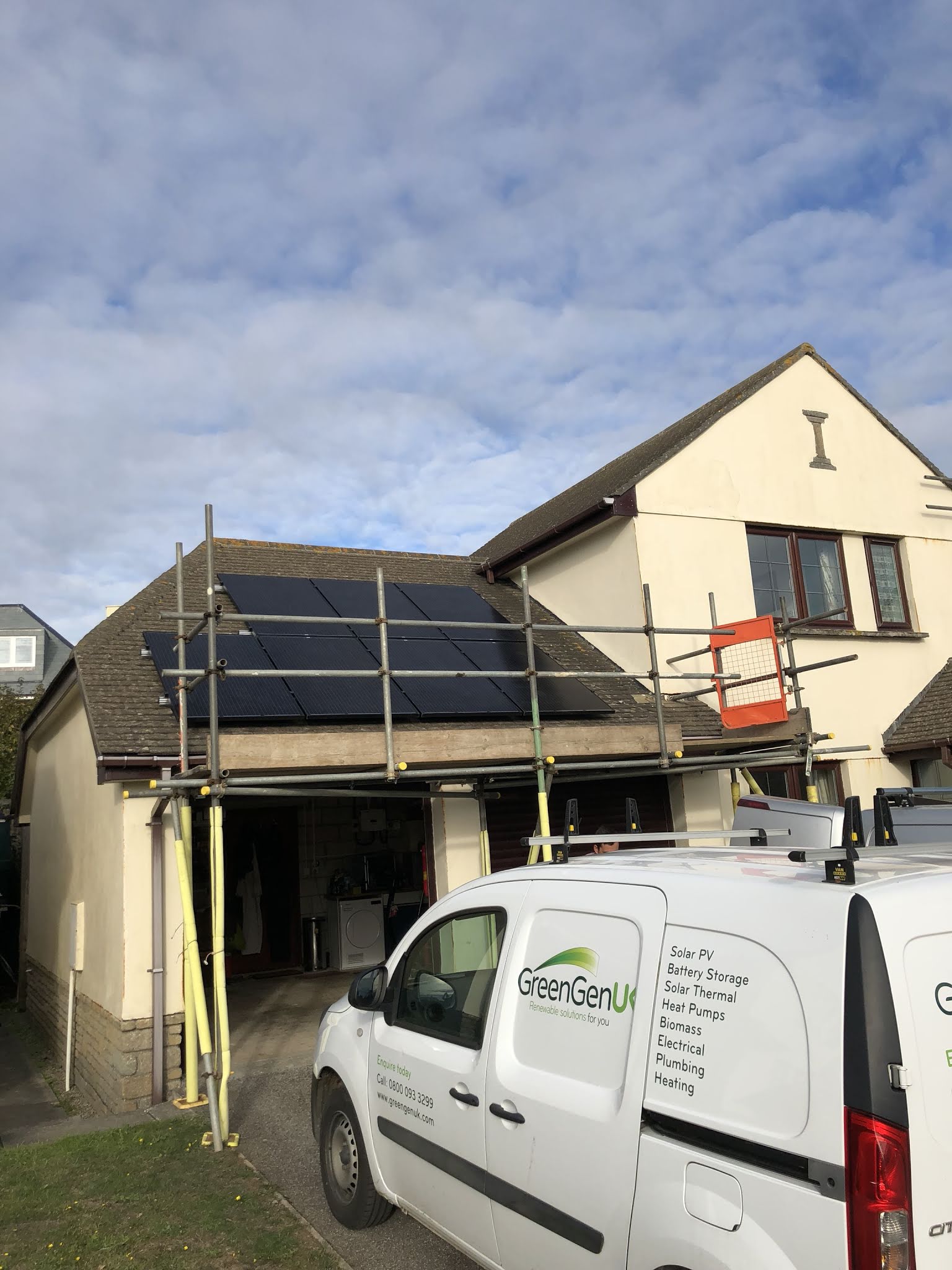 Part of a smart solar PV installation in Mullion - black solar panels on a concrete roof.