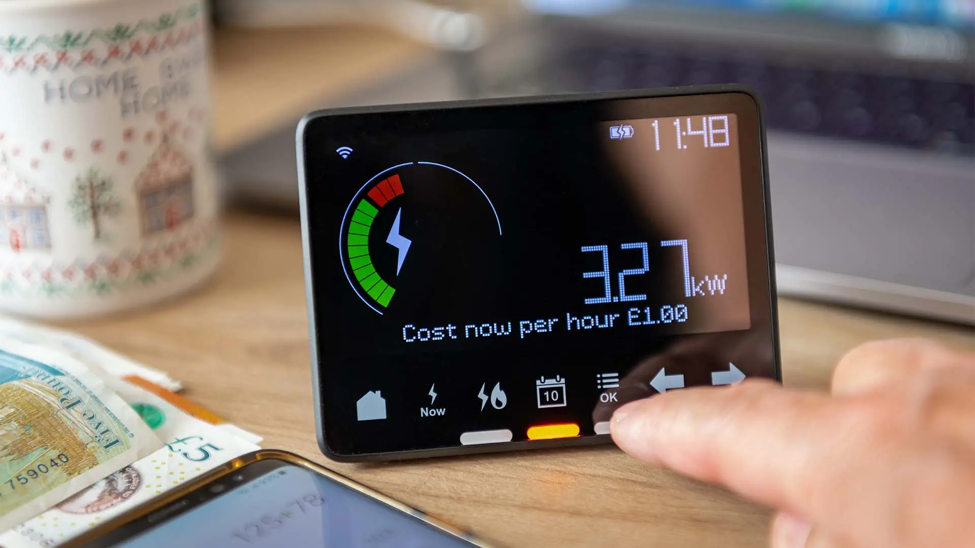 image of smart meter with hand next to it